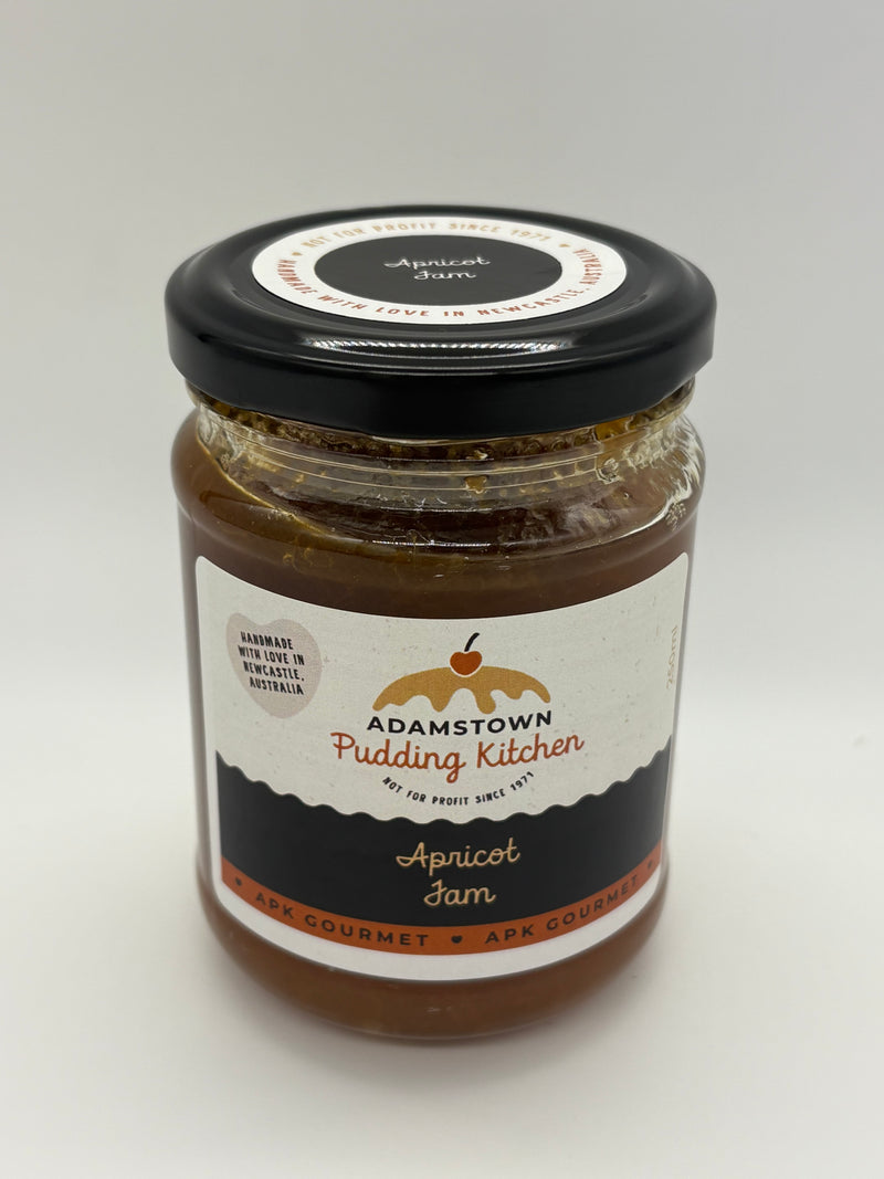 Jar of Adamstown Pudding Kitchen apricot jam on a white background