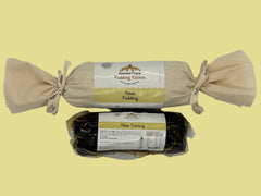 Two packages of Adamstown Pudding Kitchen Paleo Pudding one wrapped in calico with ribbon and one in a vacuum sealed bag on a white background