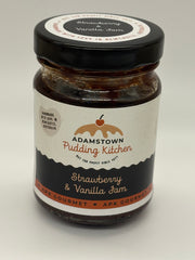 Jar of strawberry and vanilla jam with 'Adamstown Pudding Kitchen' label on a white background